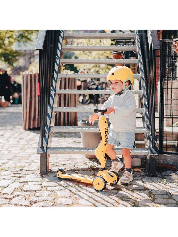 Scoot and Ride - Highwaykick 1 - Lemon in use by a child wearing a helmet, perfect for outdoor fun.