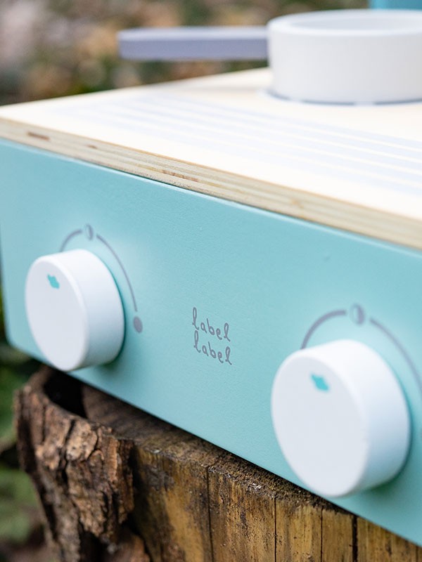 Label Label - opvouwbaar fornuis - groen, close-up van de bedieningselementen op een houten speelkeuken.